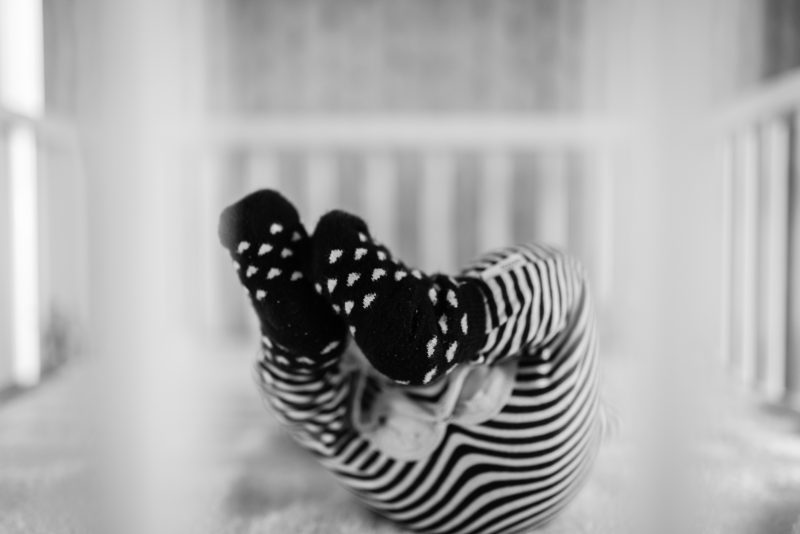 Newborn shoot gezin in Haren, fotograaf Assen, tweeling, zwart wit fotografie, kindje in de box
